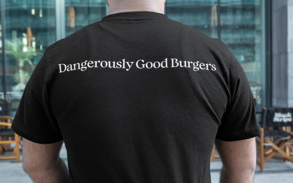 Black Stripe. T-shirt branding with slogan at back