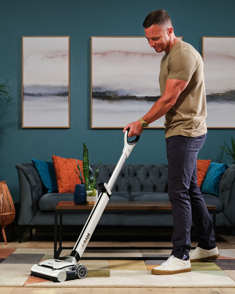 Image with a man using vacuum for Gtech Brand.