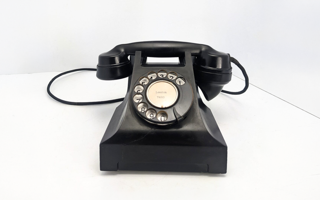A vintage black rotary dial telephone