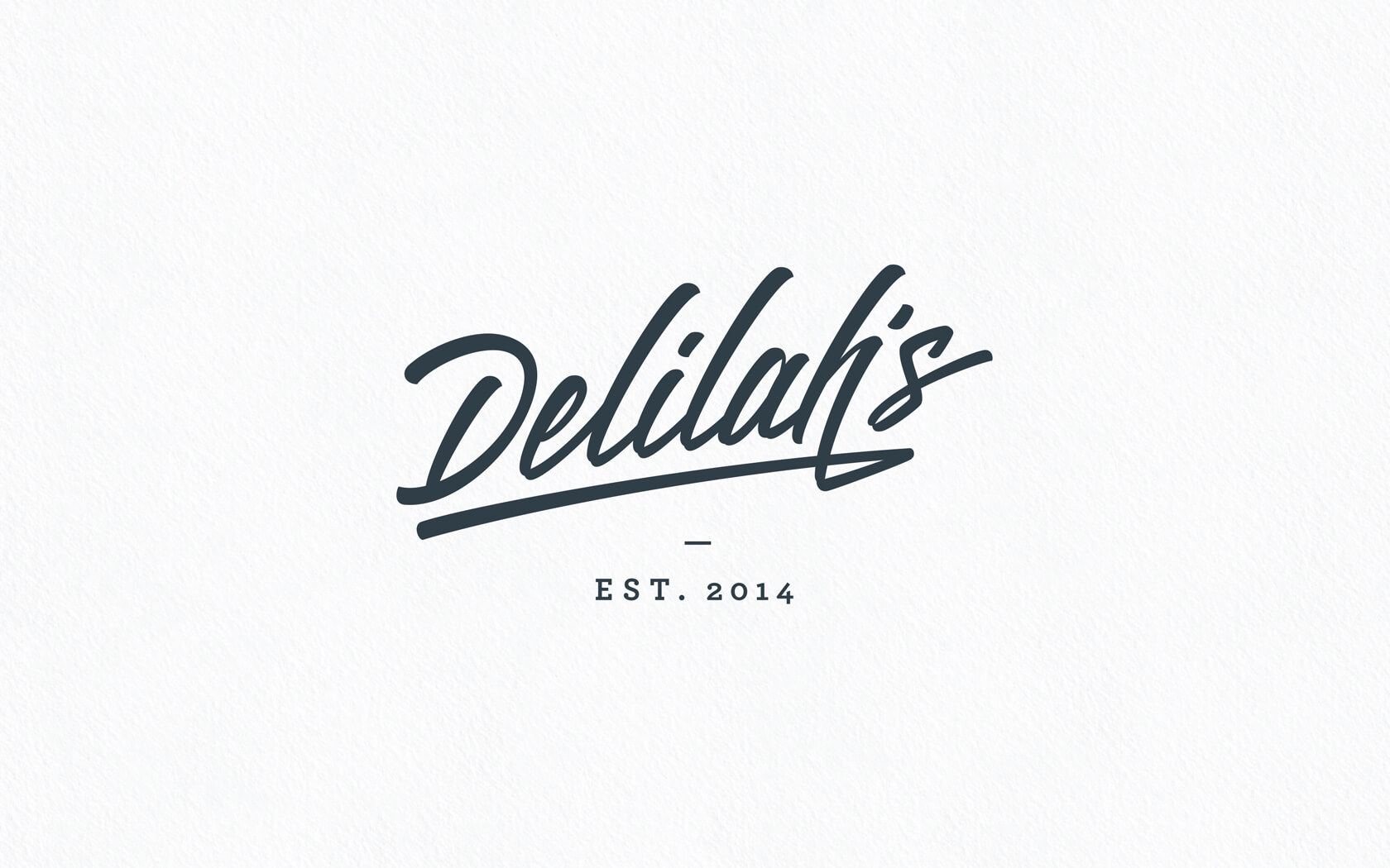 Delilah’s. Brand logo in charcoal blue