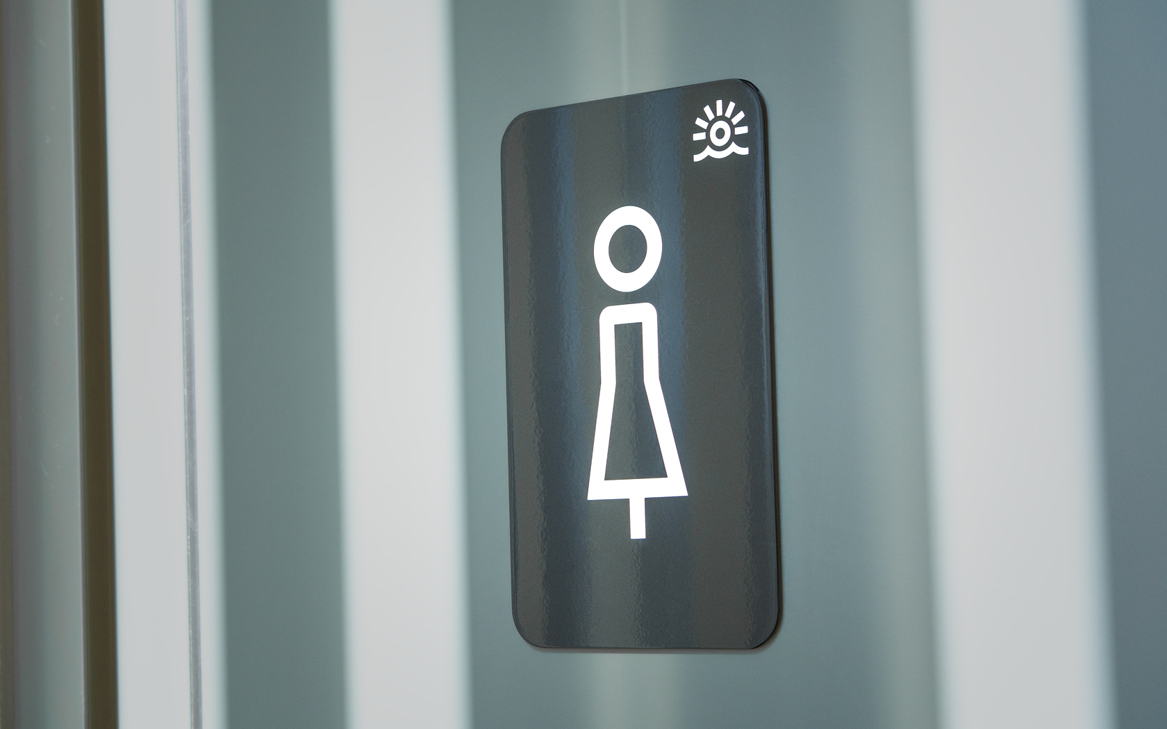 Ladies toilet sign with Brand icon for Sama Bay.